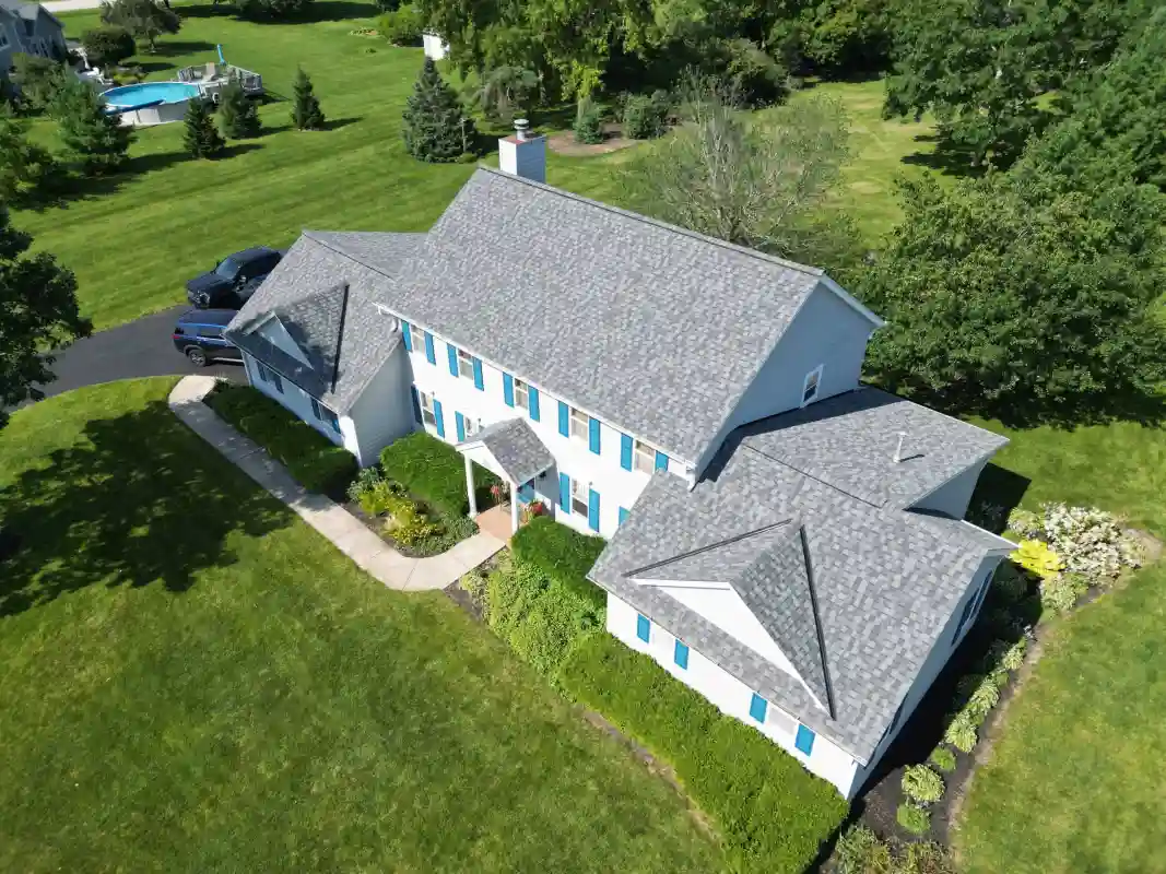Finished residential roofing project with upgraded shingles and exterior improvements
