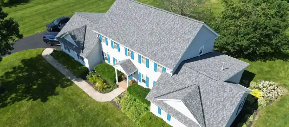 Finished residential roofing project with upgraded shingles and exterior improvements