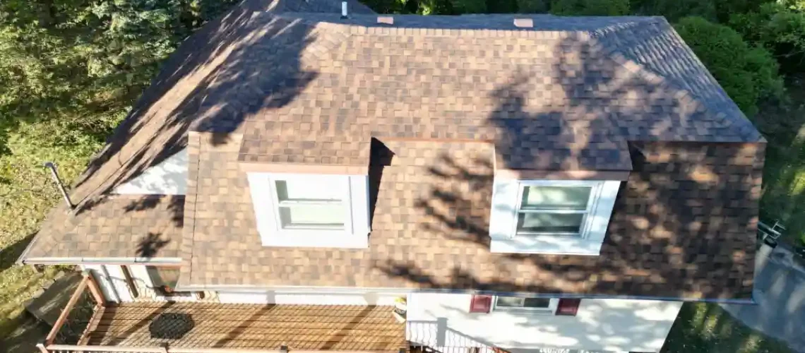Roofing project showing completed shingle installation and roof repair